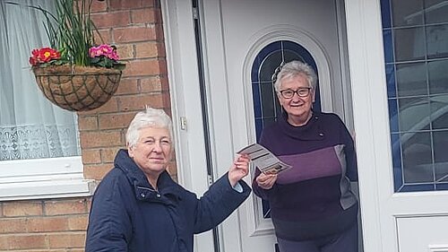 Mary on doorstep speaking to resident