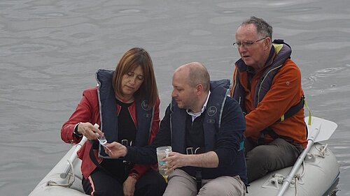 Sam Bennett and the leader of the Welsh Liberal Democrats MS testing the water quality of the river Tawe