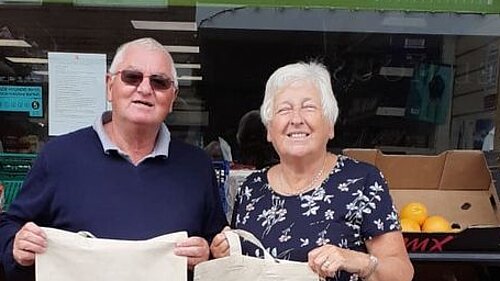 Jeff and Jones with shop local bags in Killay Precinct