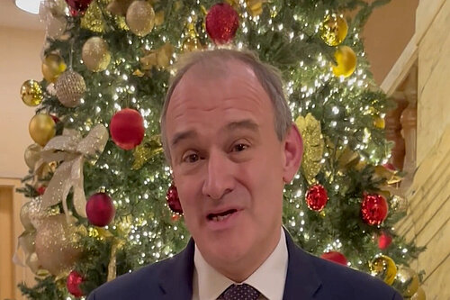 Ed Davey in front of a Christmas tree