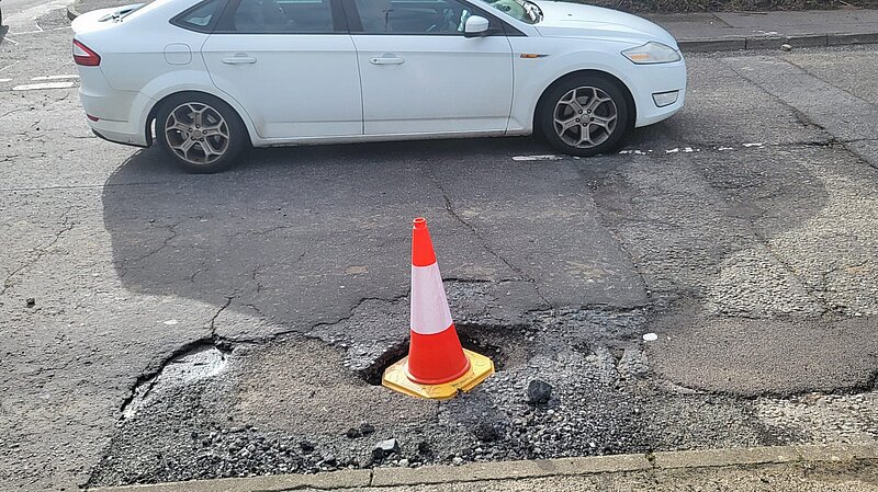 Traffic cone in a pothole